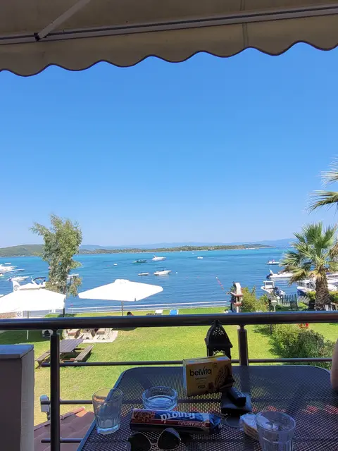 View of the bay from a studio balcony with boats on the turquoise water