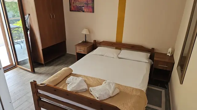 Studio bedroom with a double bed, wardrobe and balcony door