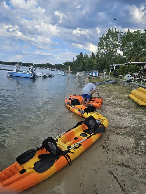 Kayaks resting in the shallow water in front of the studios